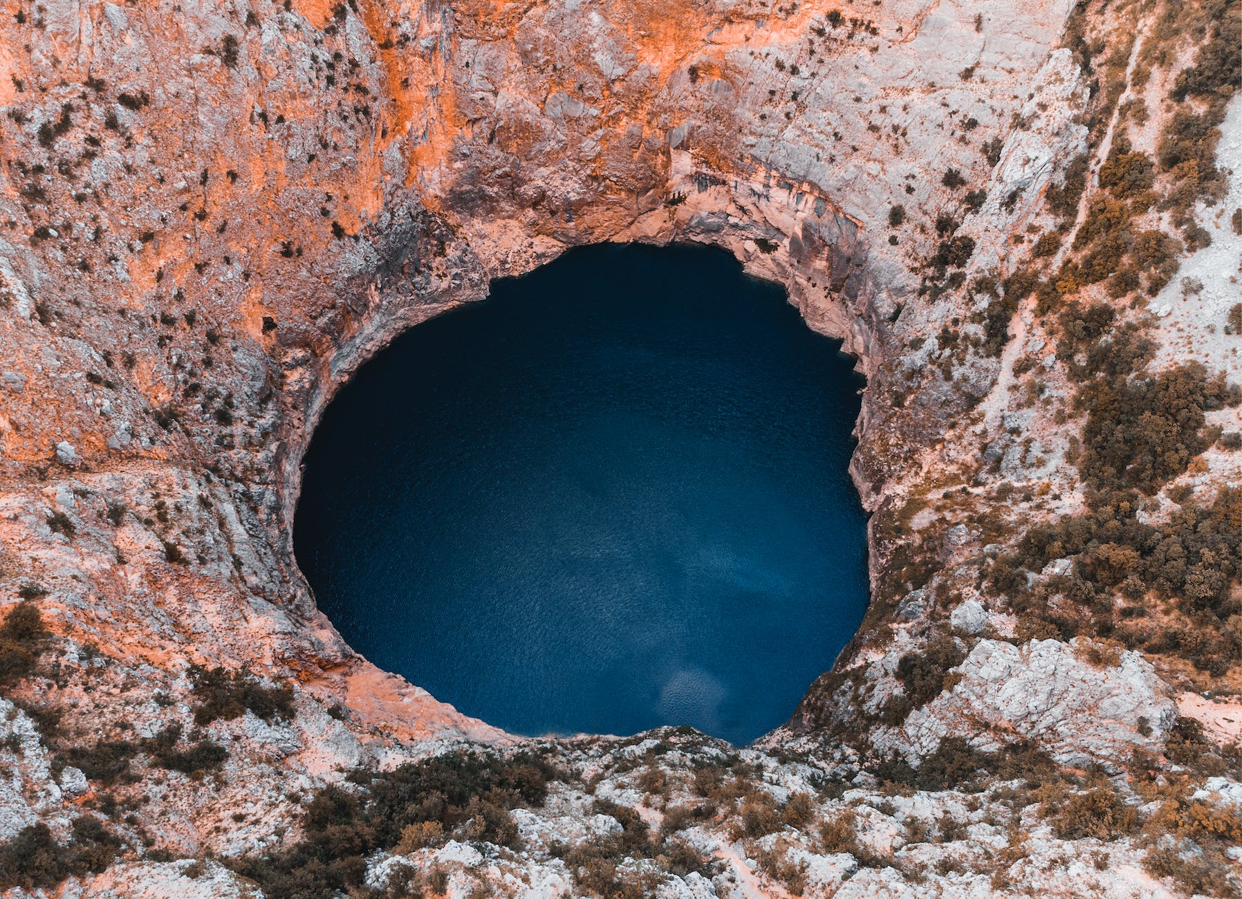 close up photography of hole and body of water