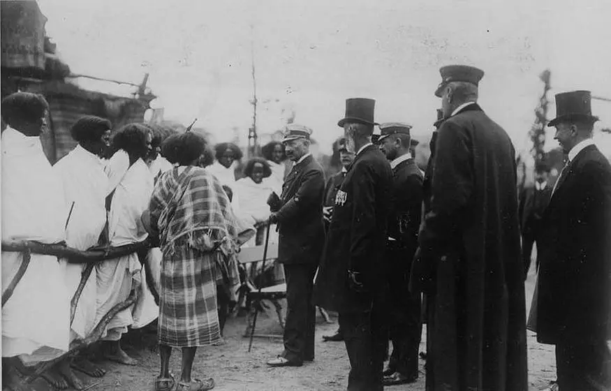 Germany’s Kaiser Wilhelm II is pictured meeting Ethiopians standing behind a wooden fence in Hamburg, Germany in 1909