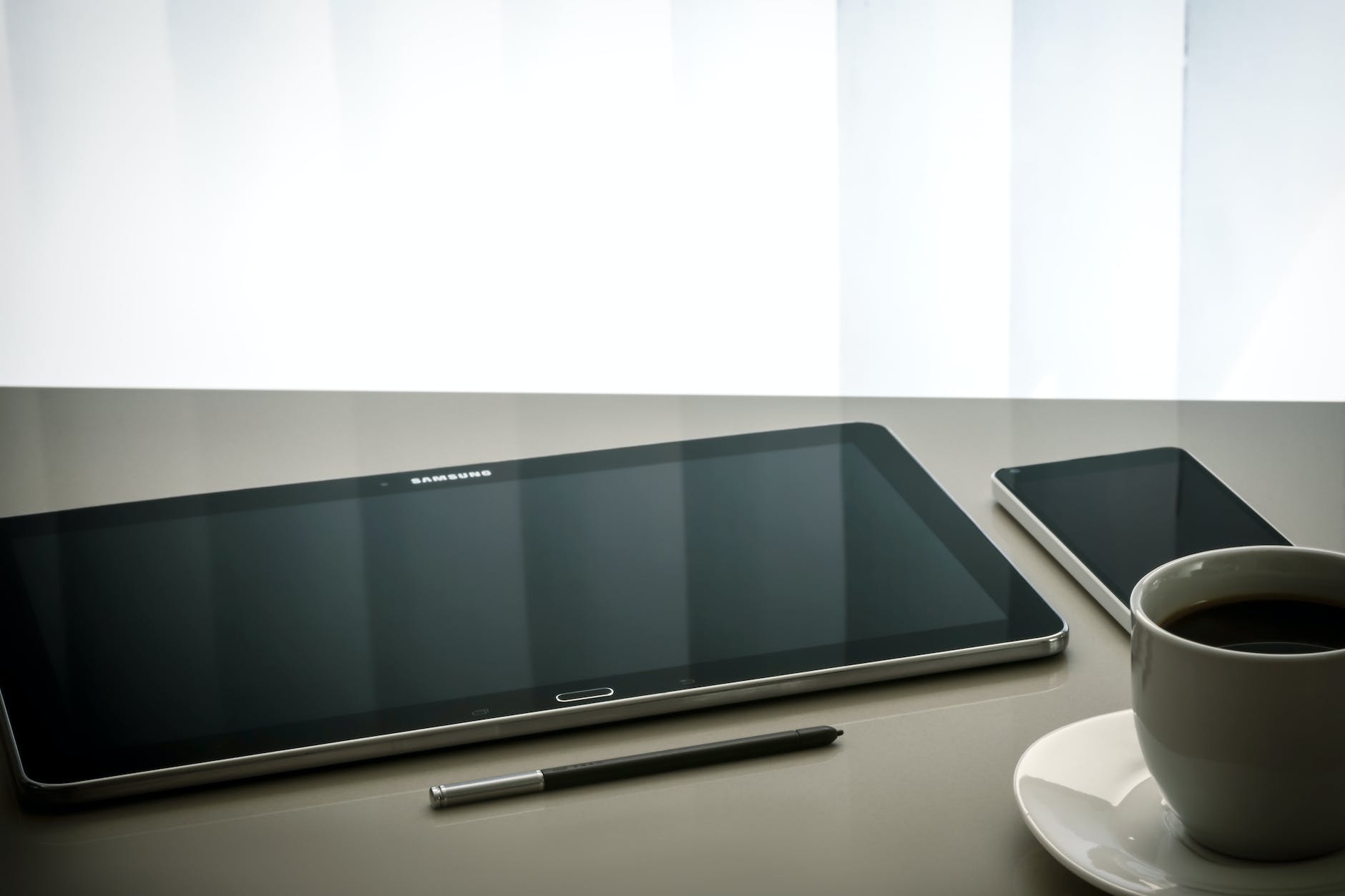 black samsung android tablet computer beside stylus pen
